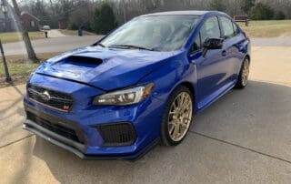 Blue Subaru outside in the sun